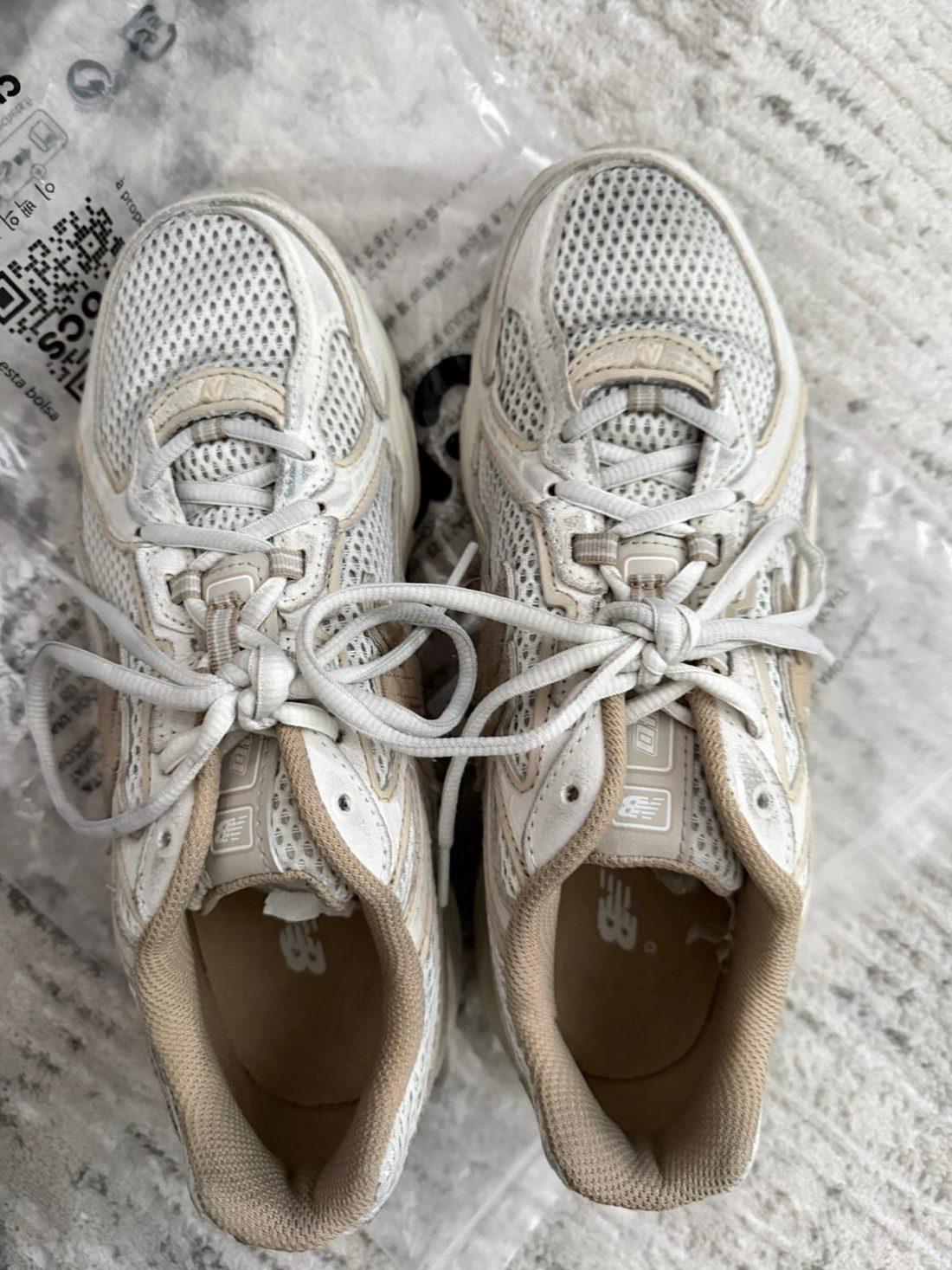 A box-fresh pair of cream New Balance trainers, cleaned and brightened after a studio clean