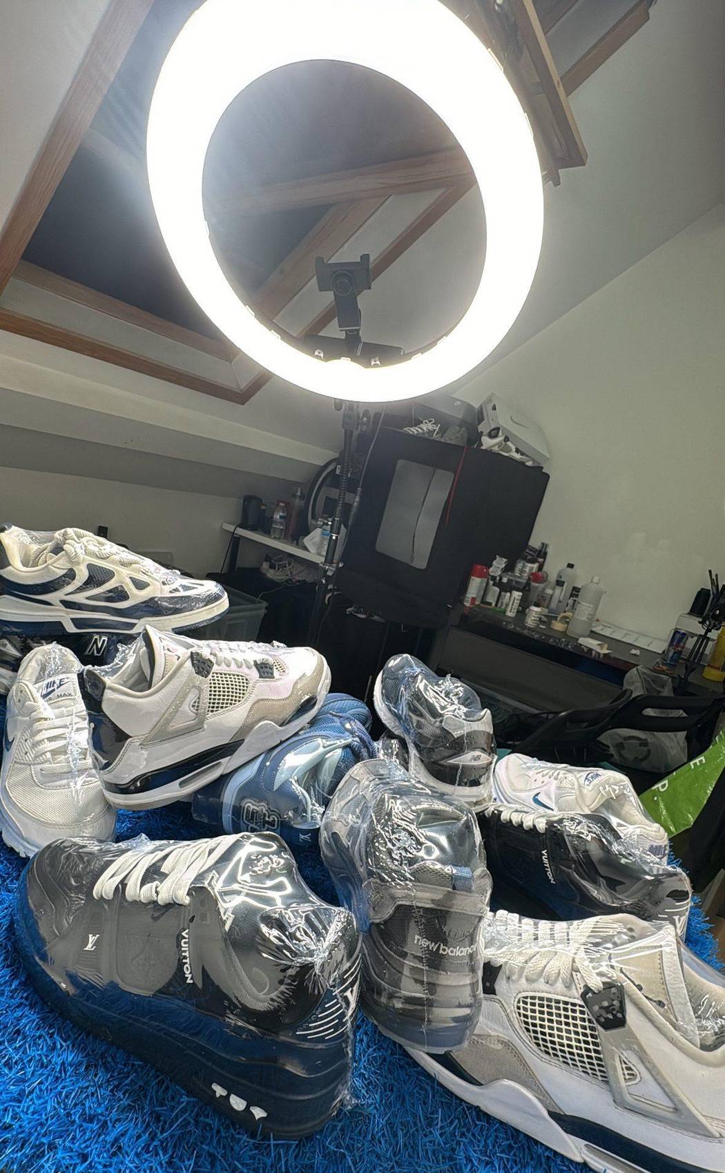 A batch of premium sneakers cleaned and wrapped under the studio ring light