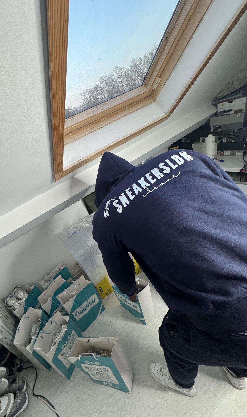 Cleaned pairs being packed into branded bags in the Sneakersldncleans studio