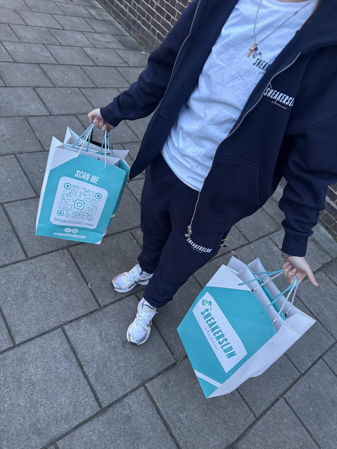 Sneakersldncleans branded tracksuit and teal bags ready to hand over